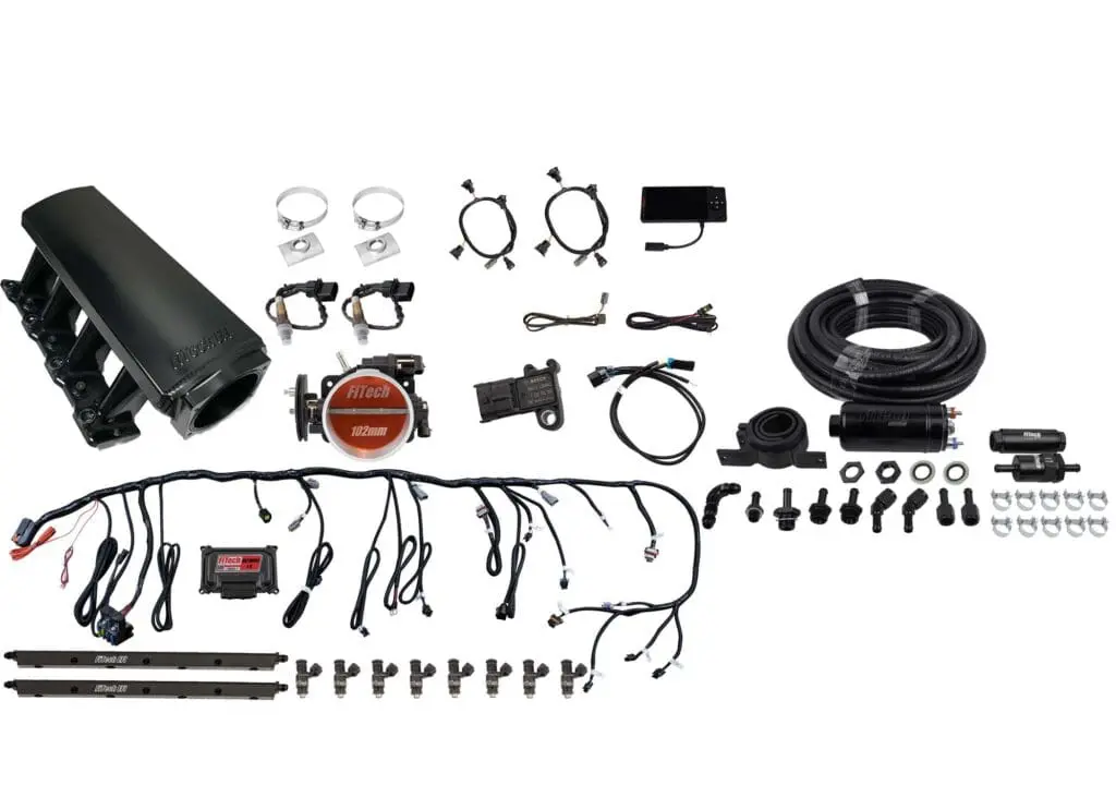 Car engine parts and accessories laid out.