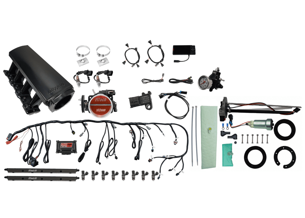 Car engine parts and accessories laid out.