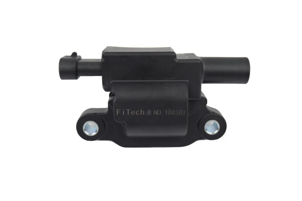 Black automotive ignition coil on white background.