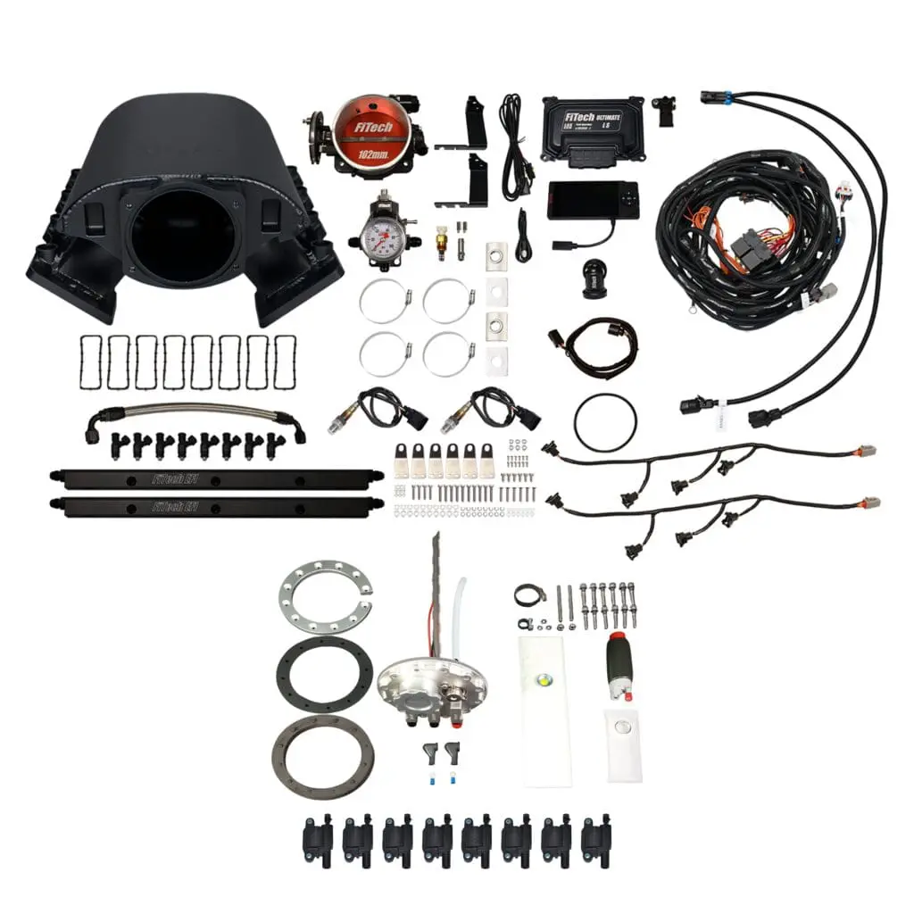 Car engine parts and accessories laid out.