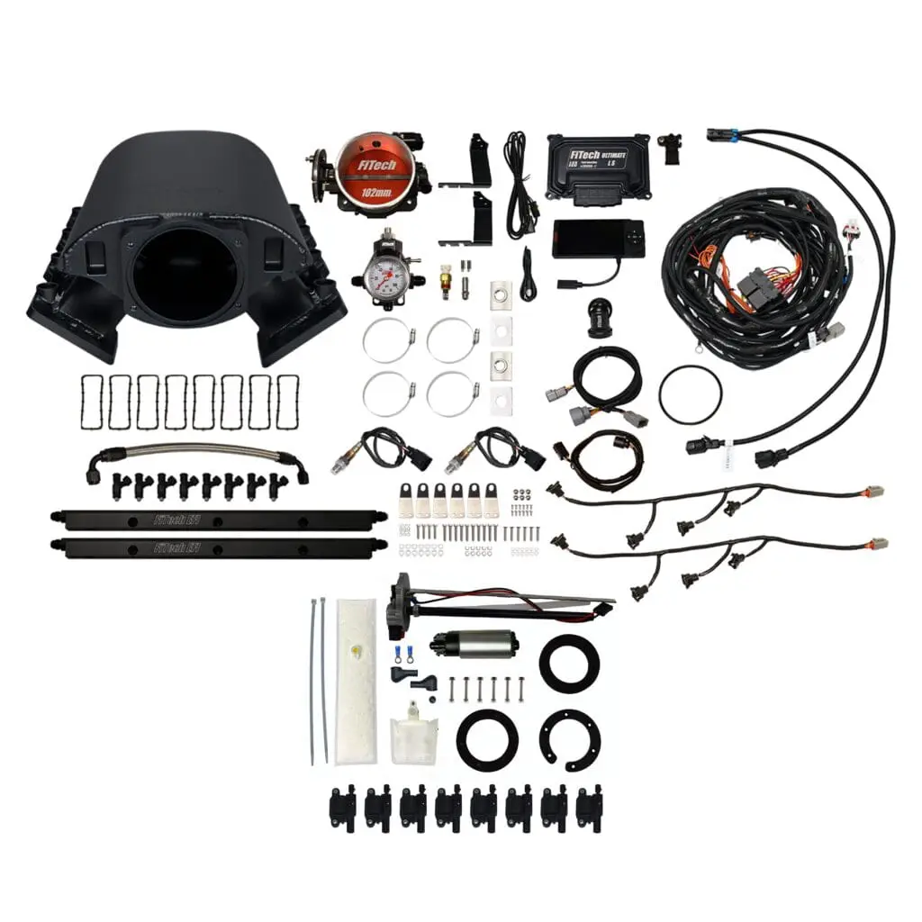 Turbocharger kit with various automotive components.