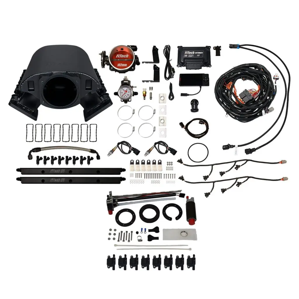 Car engine component kit laid out neatly.