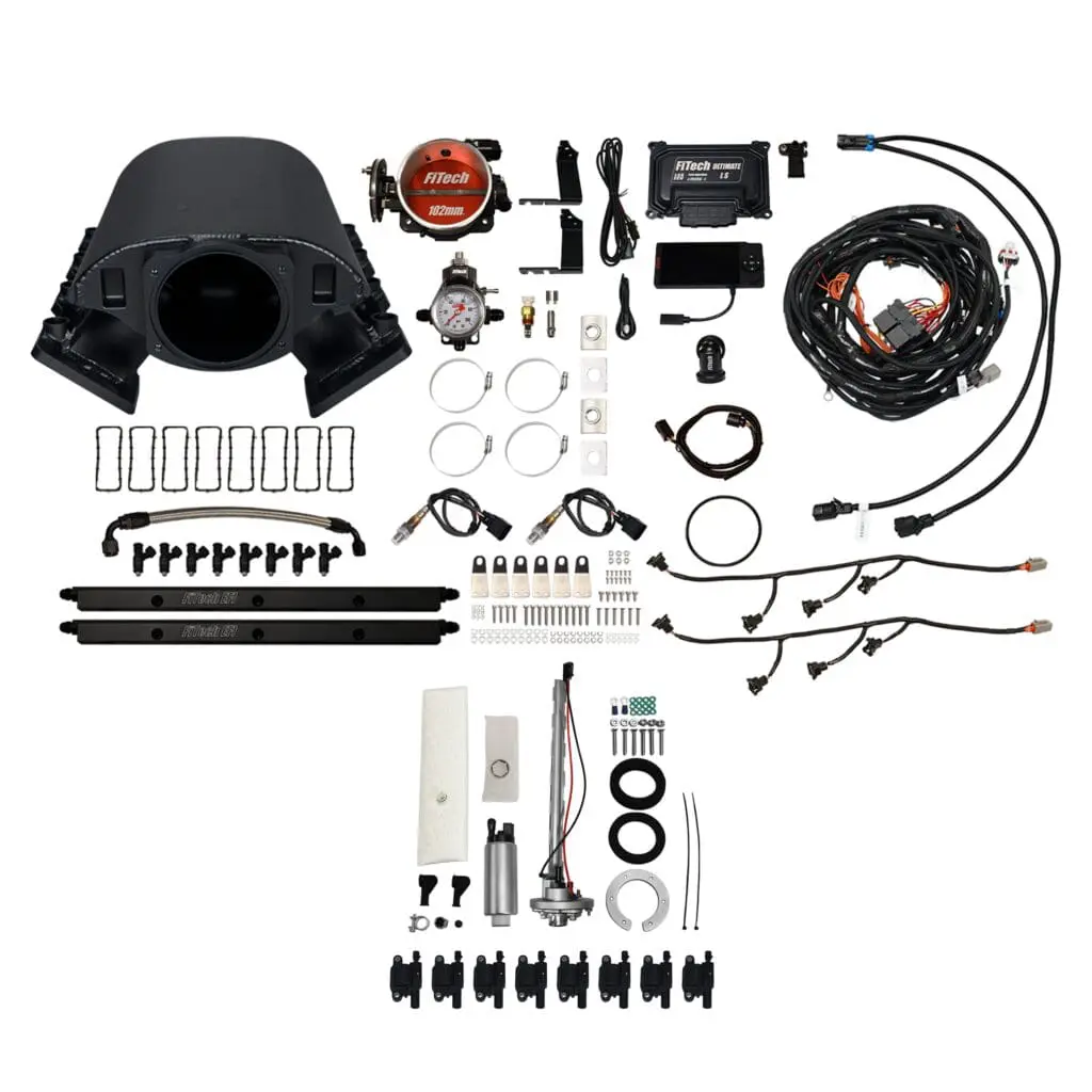 Car engine components and accessories laid out.