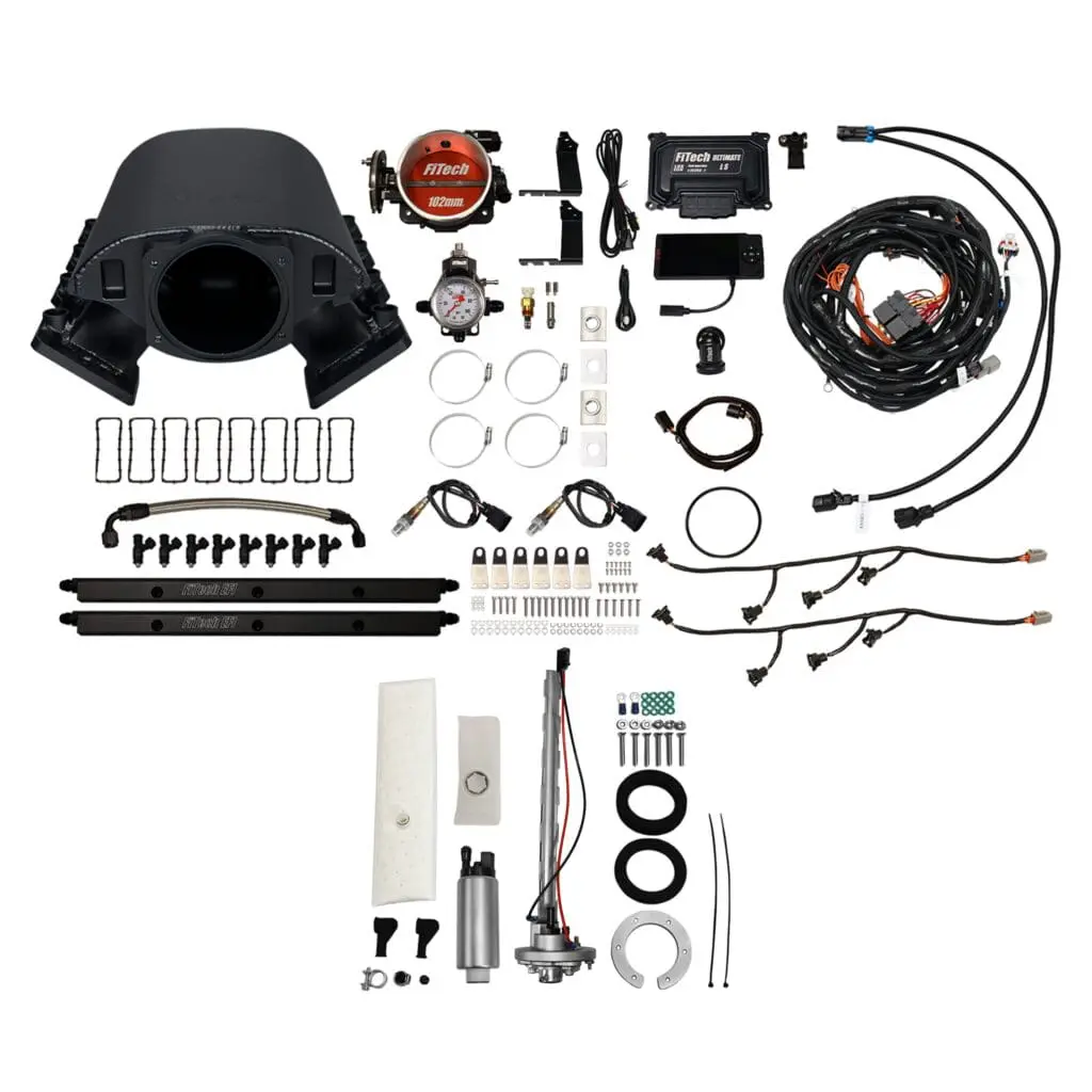 Car engine components and accessories laid out.