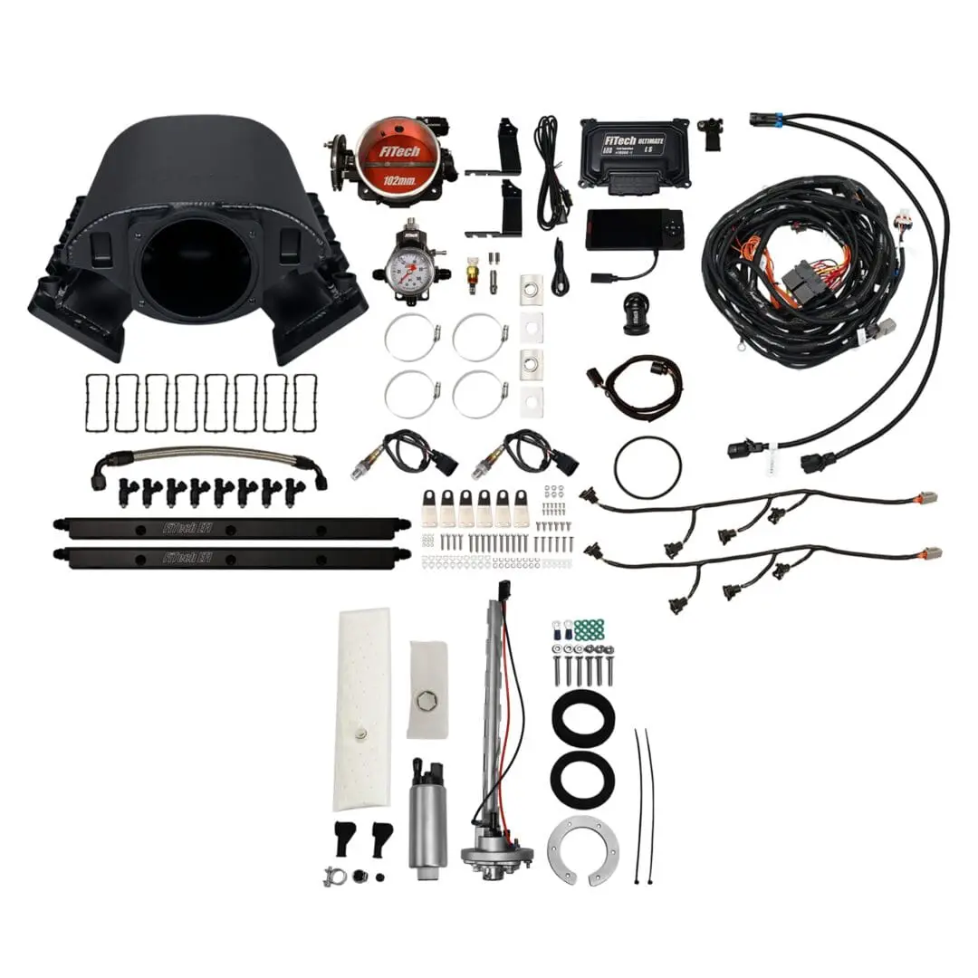 Car engine components and accessories laid out.