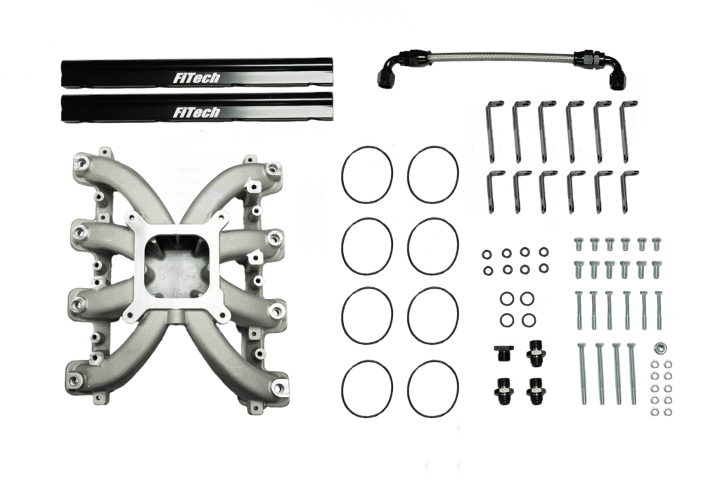 Car engine manifold and parts on display.