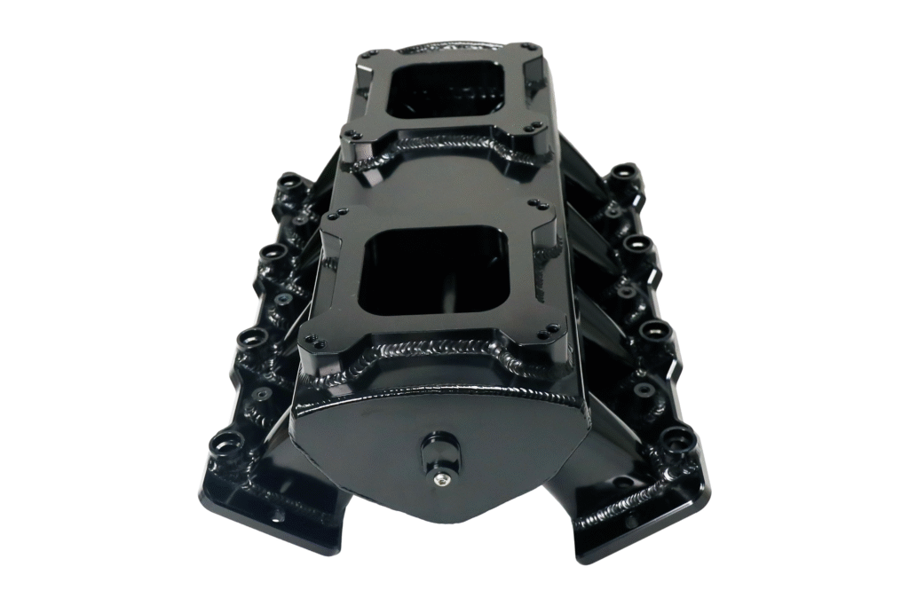 Black automotive intake manifold isolated on white background.