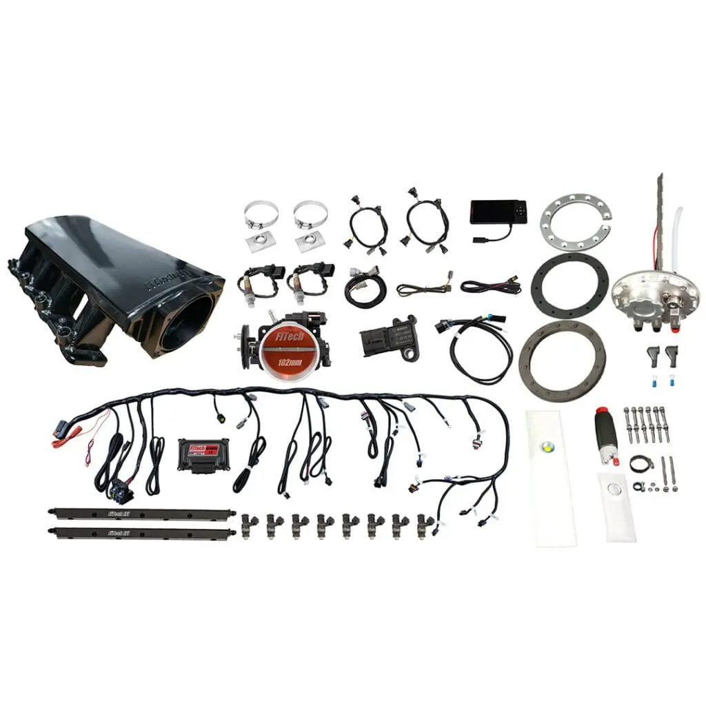 Car engine components and accessories laid out.