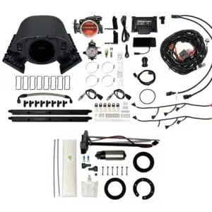 Car engine turbocharger kit components laid out.