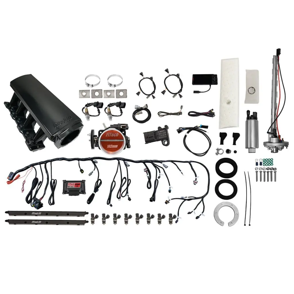 Car engine parts and wiring components displayed.