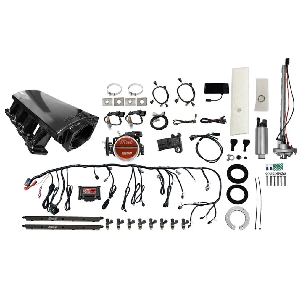 Car engine components and wiring laid out.