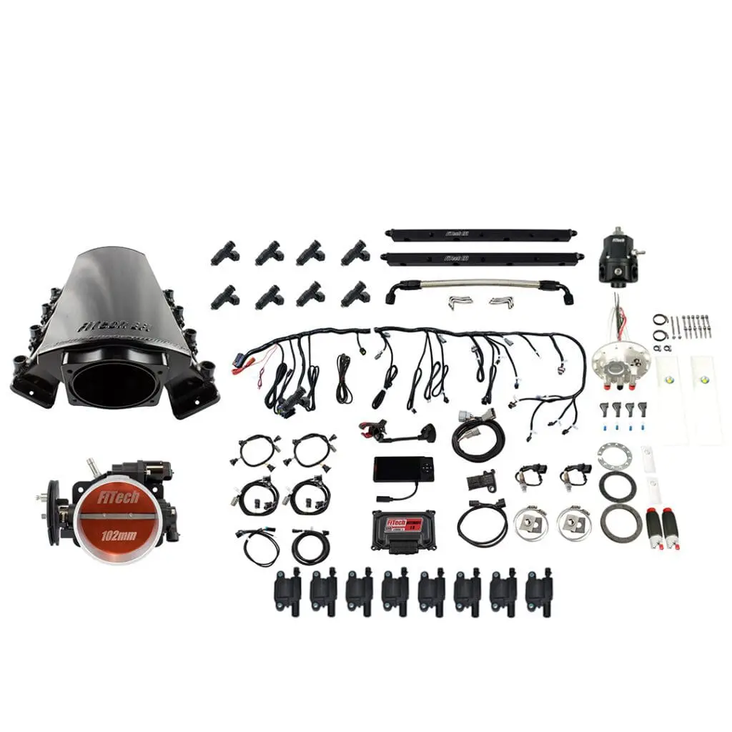 Car engine components laid out on white background.