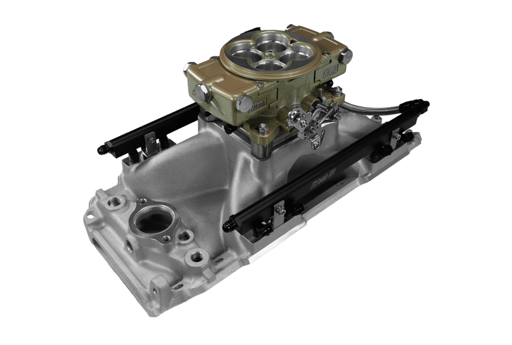 Carburetor on engine manifold, black background.