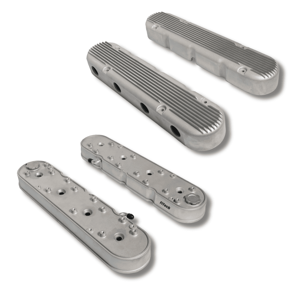 Silver engine valve covers, ribbed and smooth.