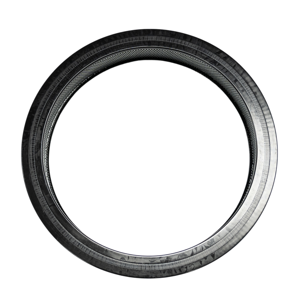 Black circular tire with textured inner edge.
