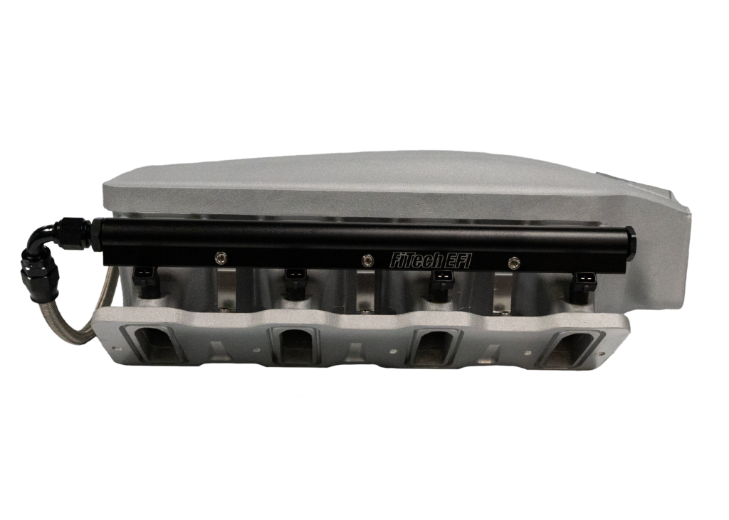 Engine intake manifold on black background.