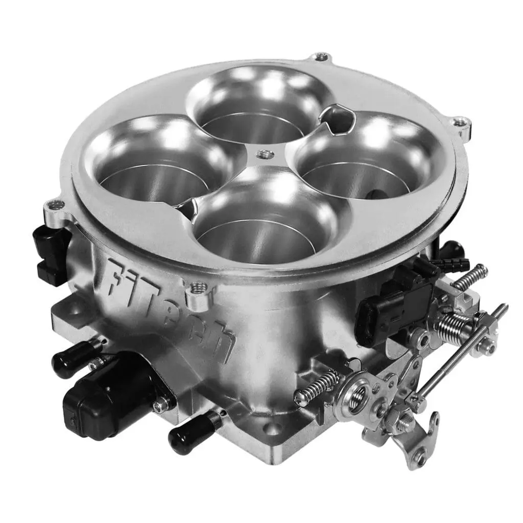 A metal carburetor with four circular chambers for fuel mixing.