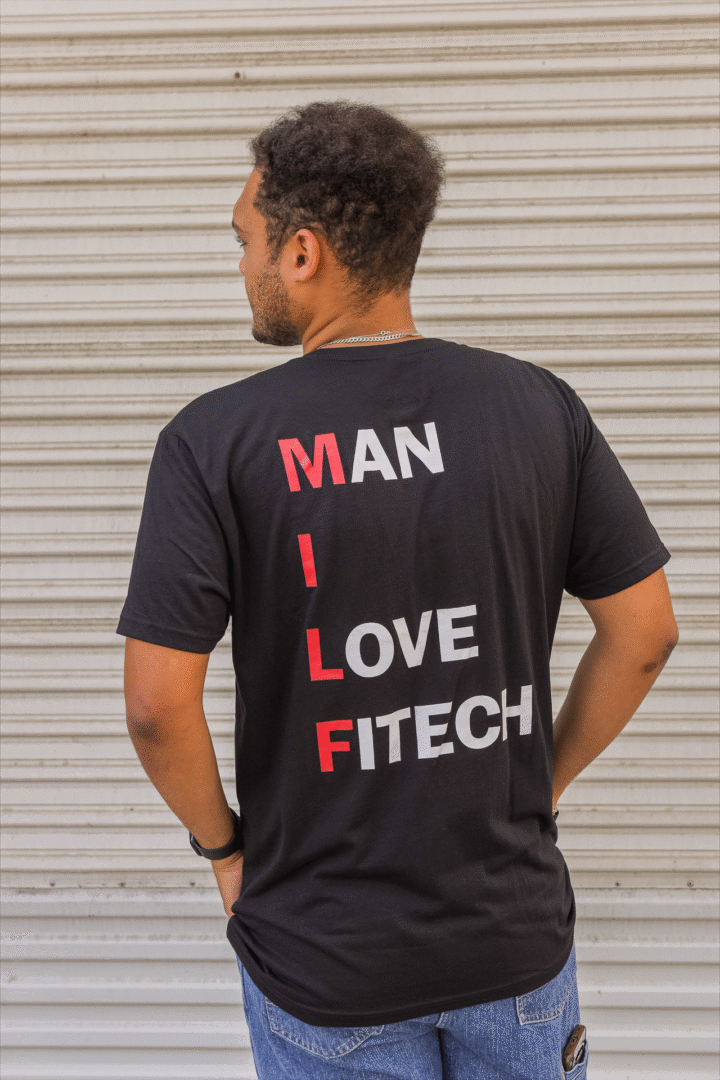 Man wearing a black T-shirt with 'MAN I LOVE FITECH' printed vertically.