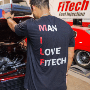 Person wearing a black FiTech shirt with a slogan about fuel injection.