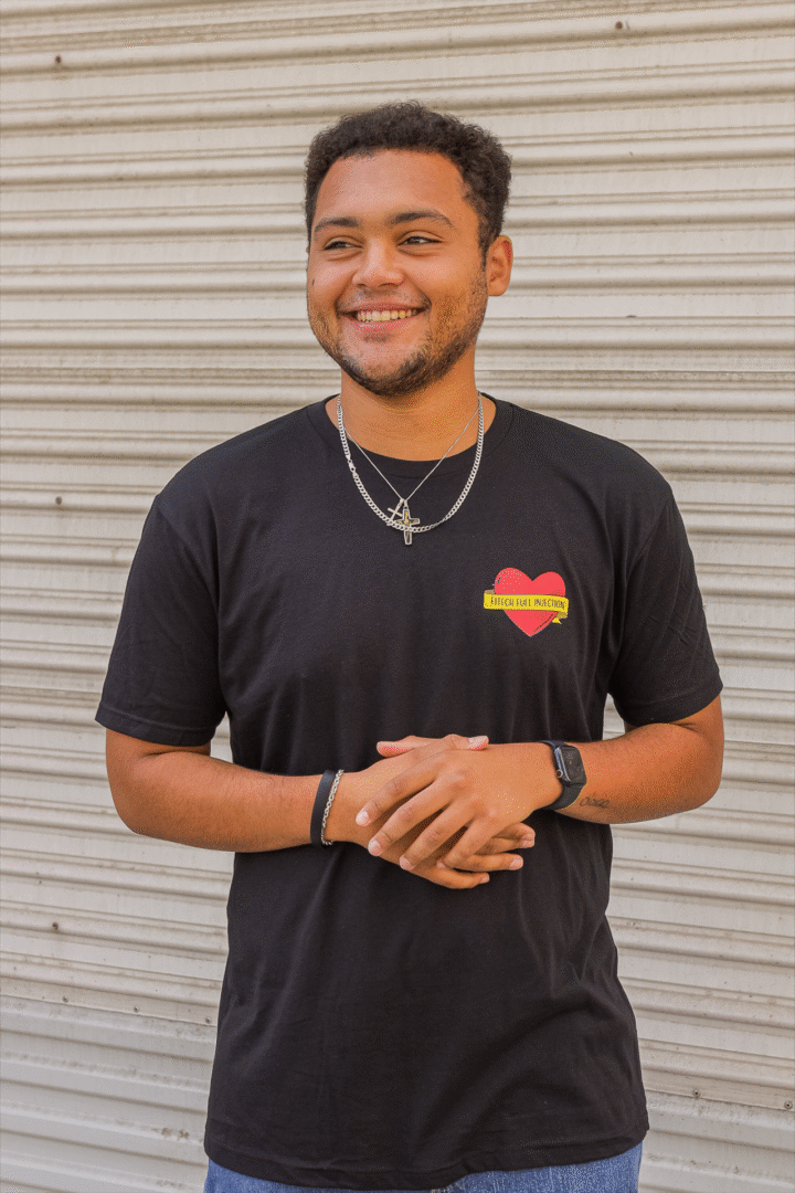 Smiling young man in black t-shirt with heart design.