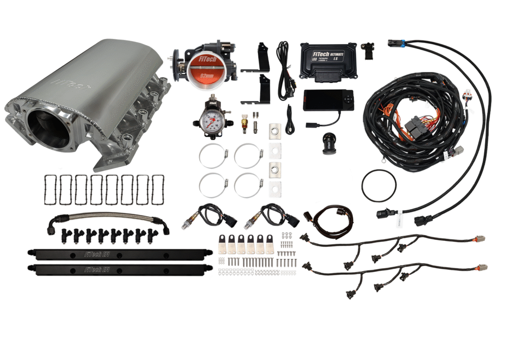 Complete automotive supercharger kit with various components and wiring.