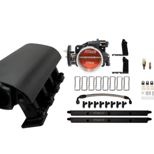 Car engine ignition coil and related components laid out on a white surface.