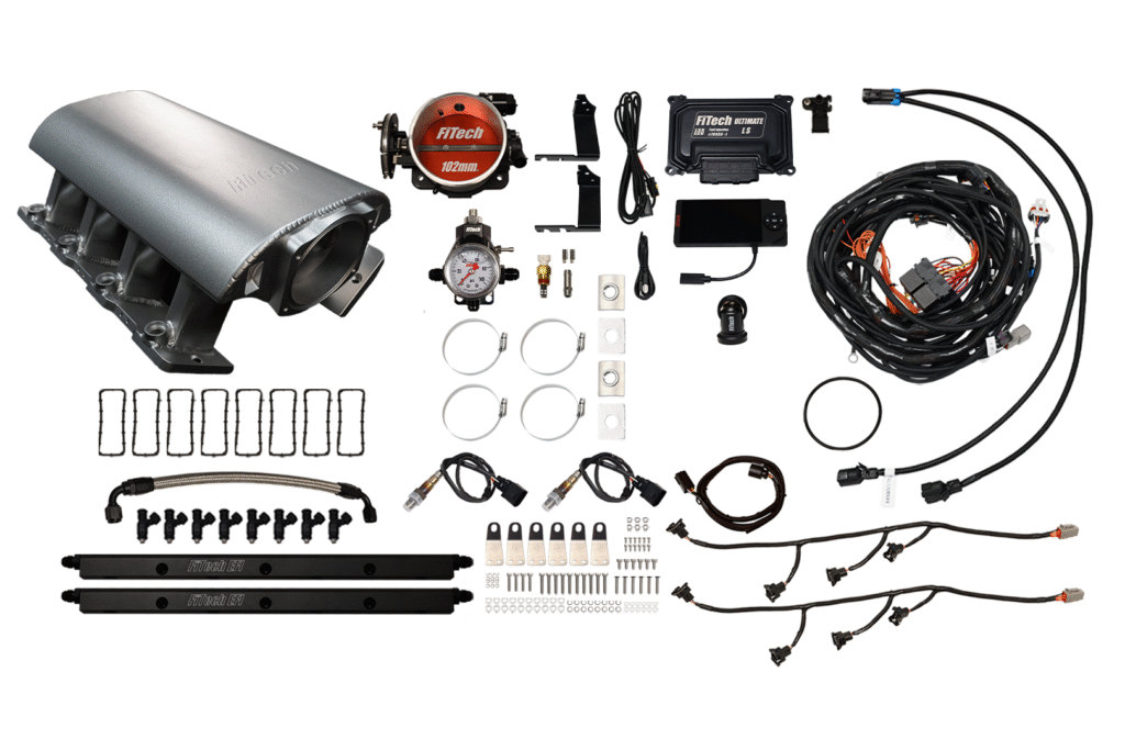 Disassembled automotive turbo kit with various components.