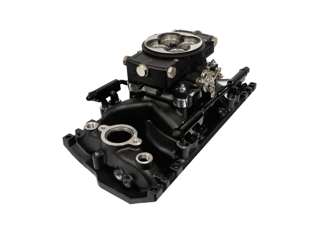 A black automotive intake manifold with attached carburetor.