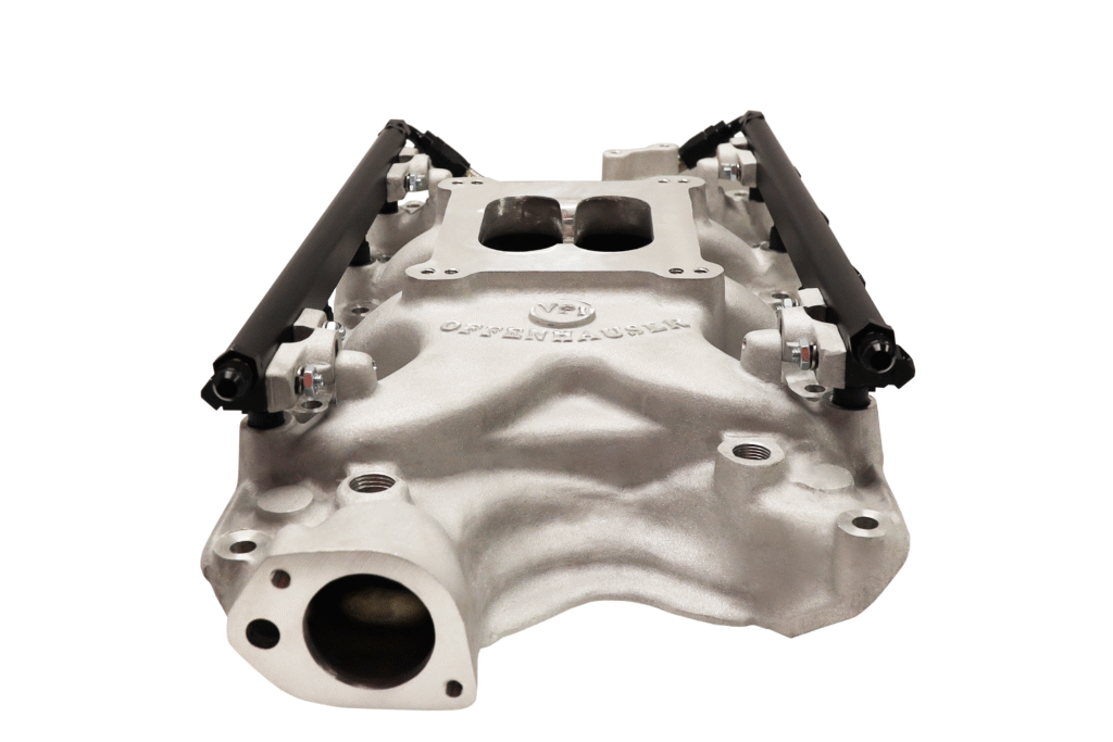 Silver engine intake manifold with fuel rails attached.
