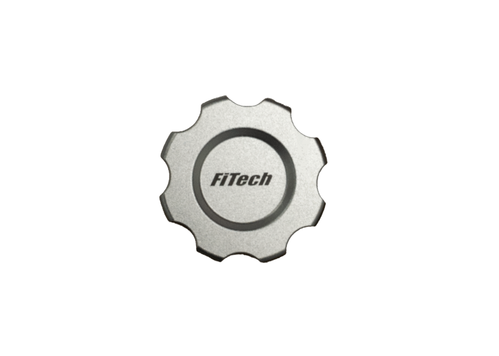 A silver metallic cap with the text 'FiTech' engraved on it.