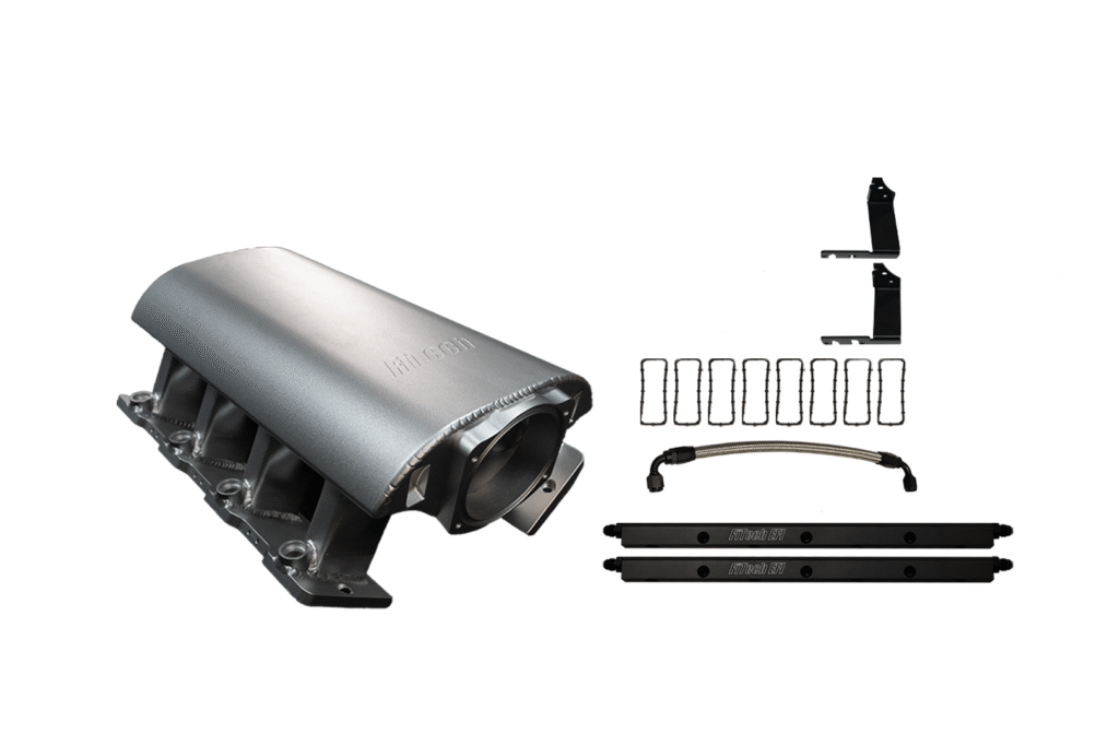 Silver automotive intake manifold with black components on white background.