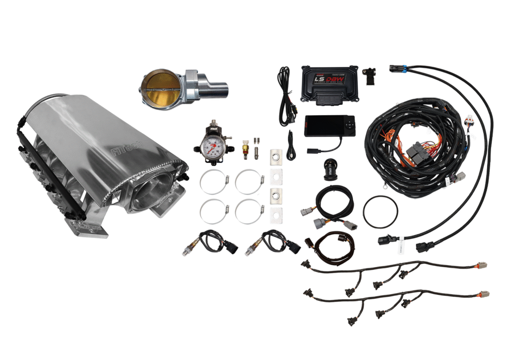 A collection of automotive parts and wiring components laid out on a white surface.