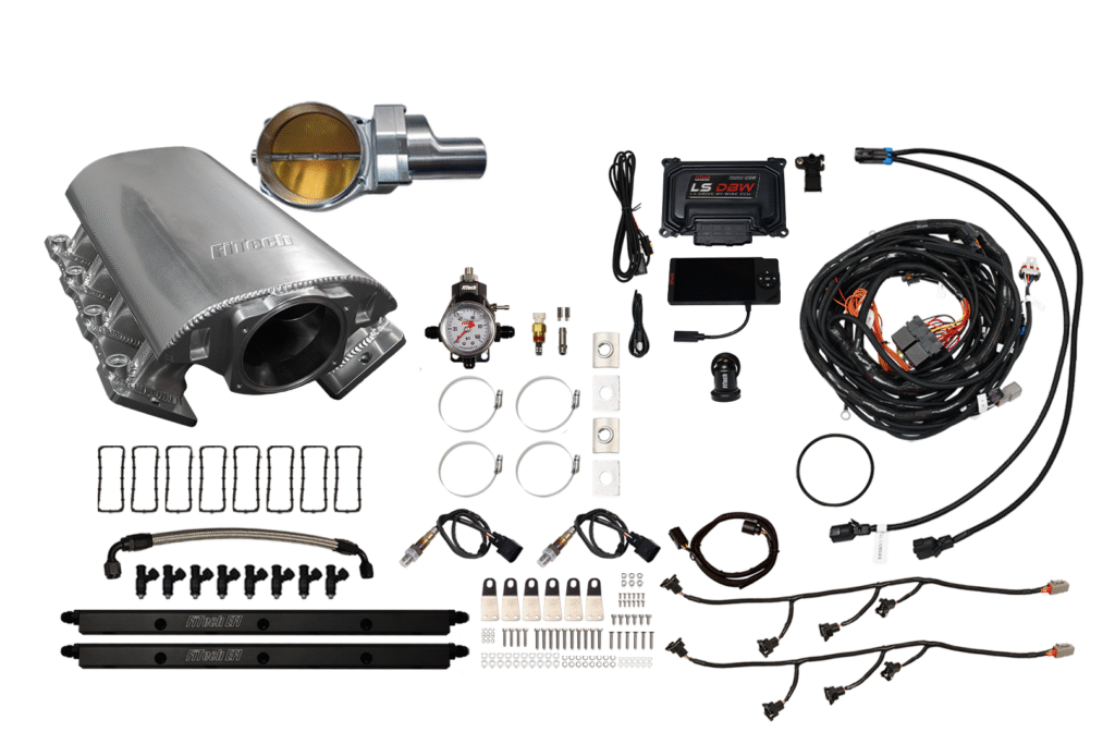 Car exhaust system and various automotive parts laid out on a white surface.