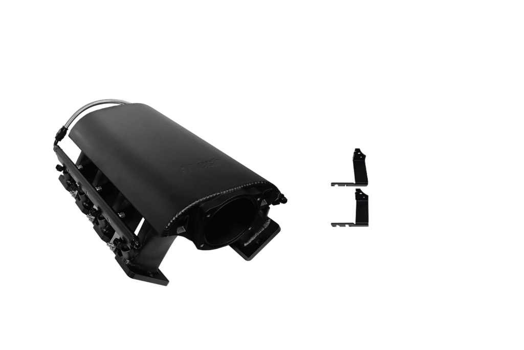 Black plastic electronic device part with a small detached component beside it.