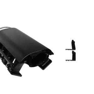 Black plastic electronic device part with a small detached component beside it.