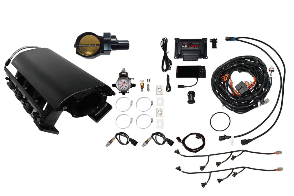 Complete car turbo kit with various components and wiring.