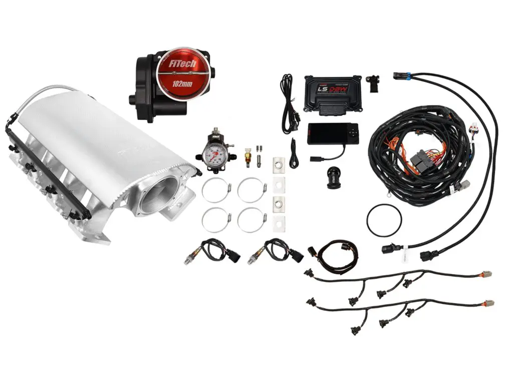 A disassembled turbocharger kit with various components and wiring.