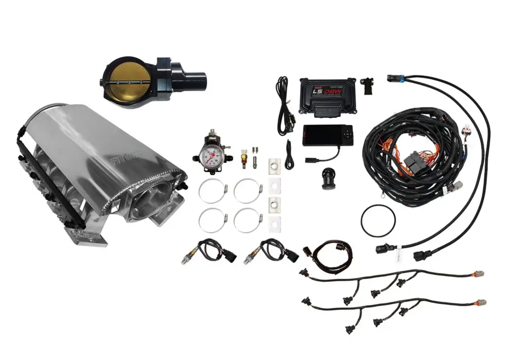 Car engine components and wiring kit laid out on a white background.