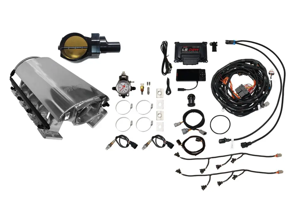 A collection of automotive engine parts and accessories laid out on a white background.