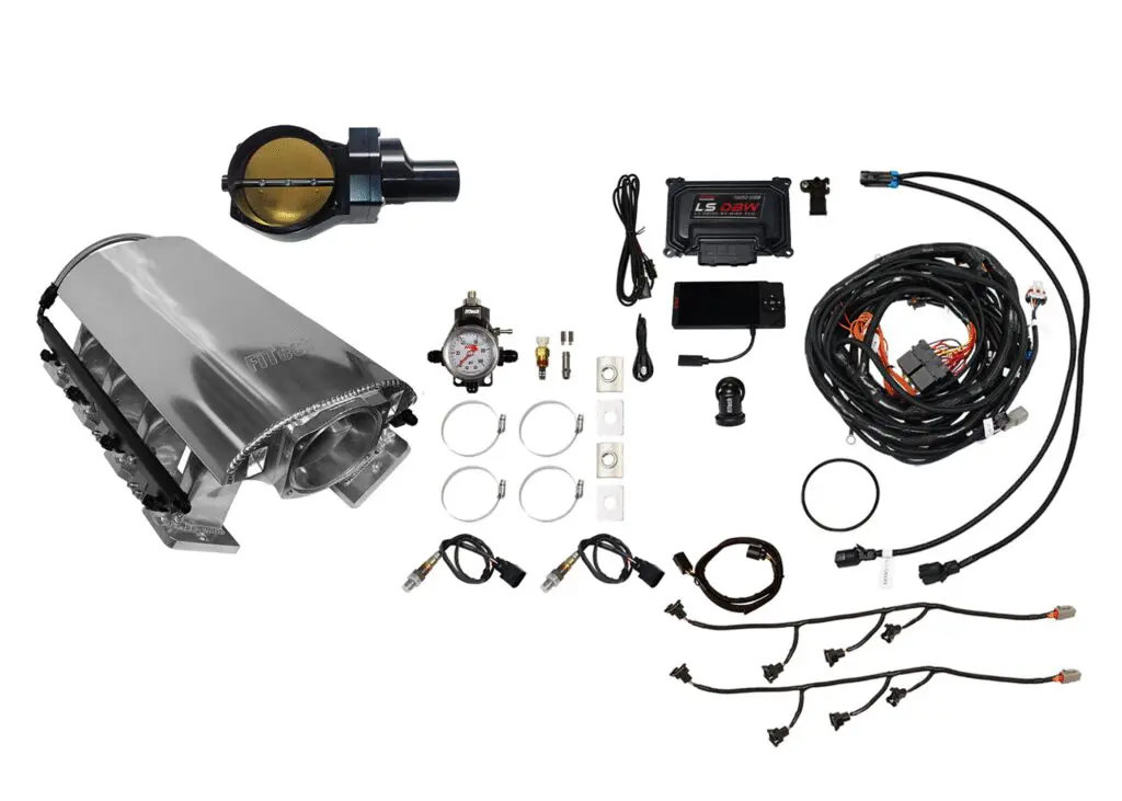 Car engine parts and wiring components laid out on a white background.