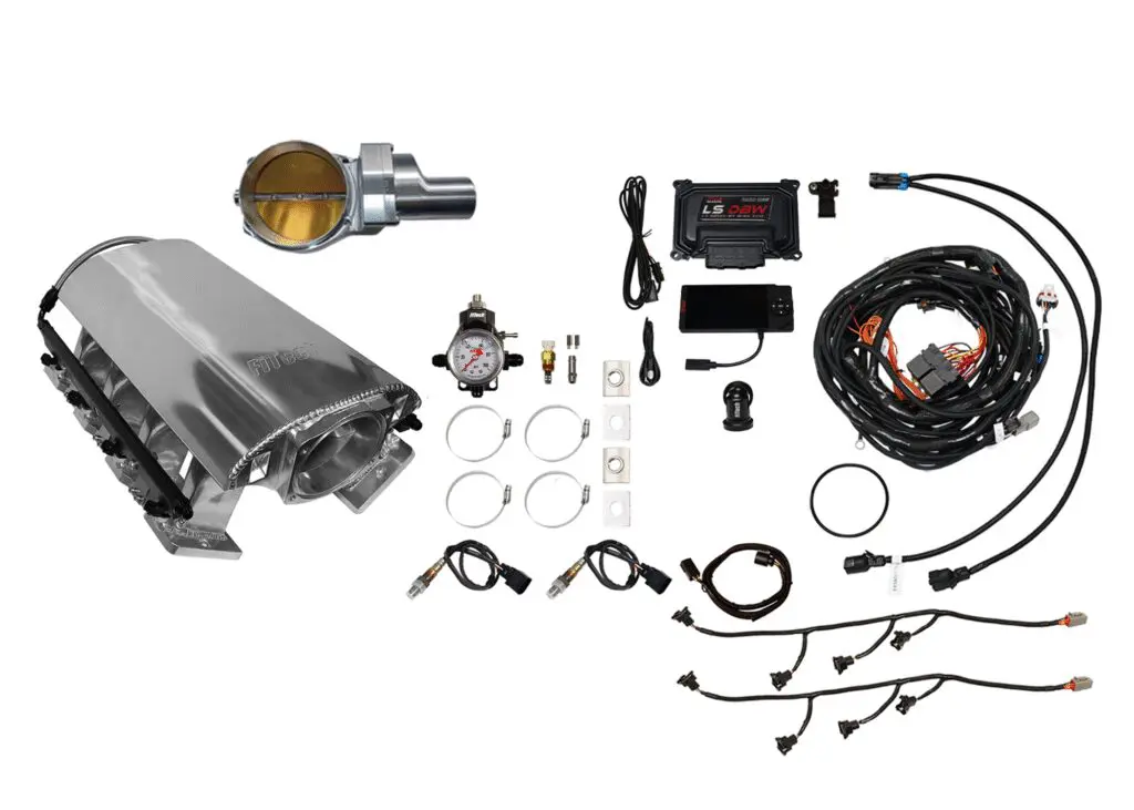 A collection of automotive engine parts and wiring components.