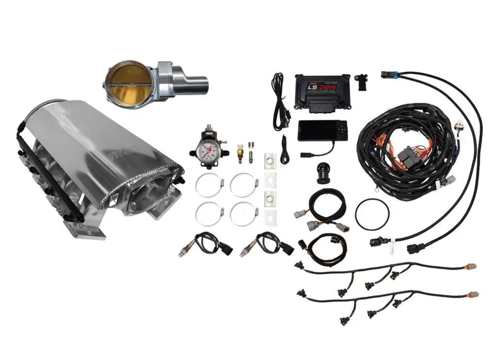 Complete automotive engine tuning kit with various components and wiring.
