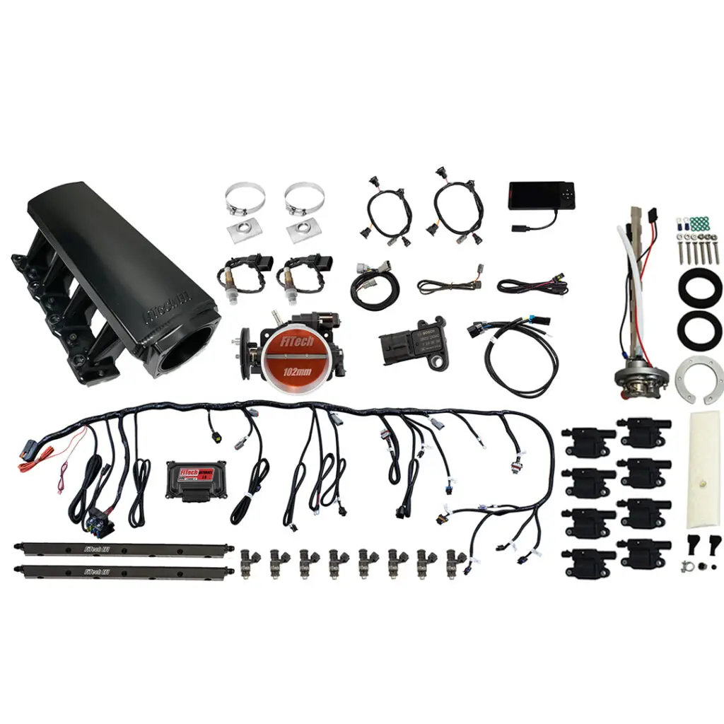 A collection of various mechanical and electronic parts laid out on a white surface.