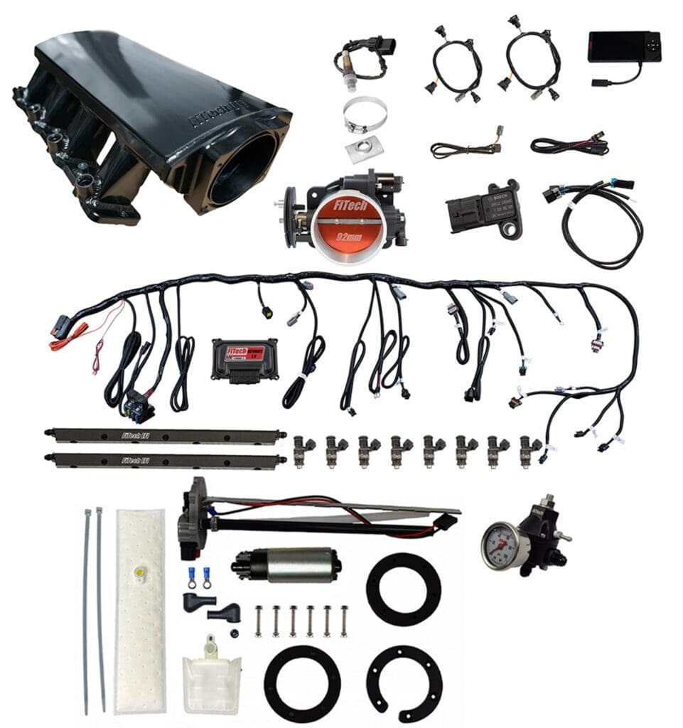Car engine parts and wiring kit displayed.