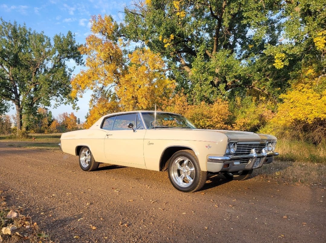 Classic car parked on a rural road.