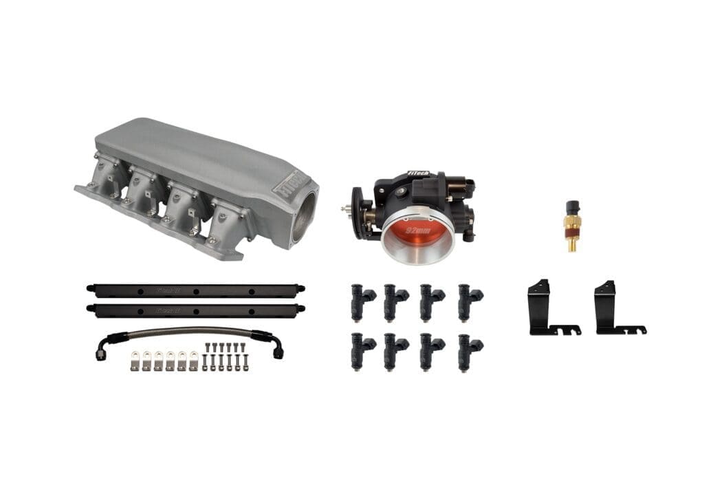 Car engine parts kit, various components displayed.