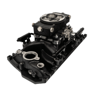 A black automotive intake manifold with attached carburetor.