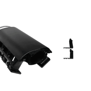 Black plastic electronic device part with a small detached component beside it.