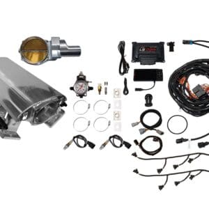 A collection of automotive parts and tools laid out on a white surface.