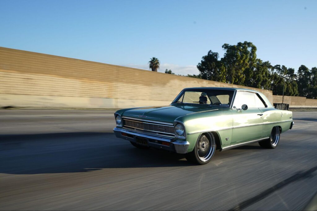 green car driving down the highway